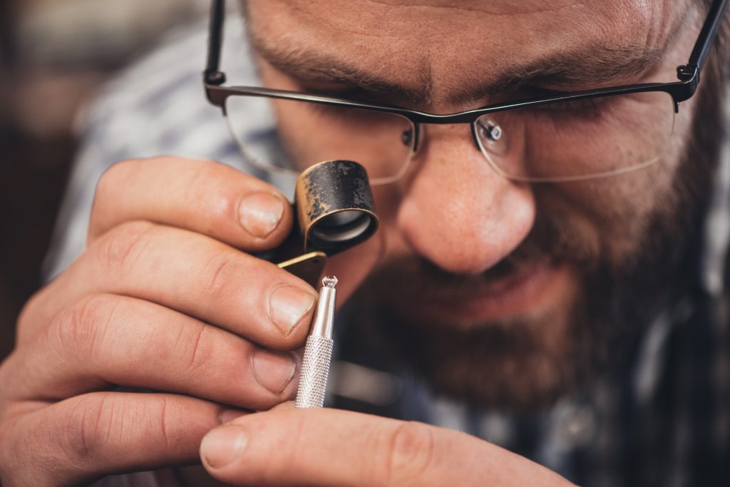 man examining jewelry